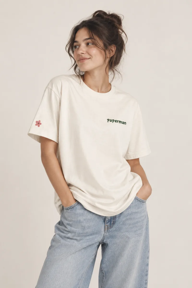 Model wearing the cream embroidered Paperman tee